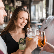 young-smiling-woman-toasting-drinks-with-her-friends (1)